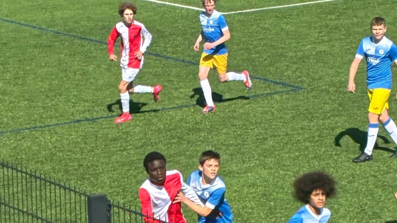 Sussex Schools players competing in a youth football match.